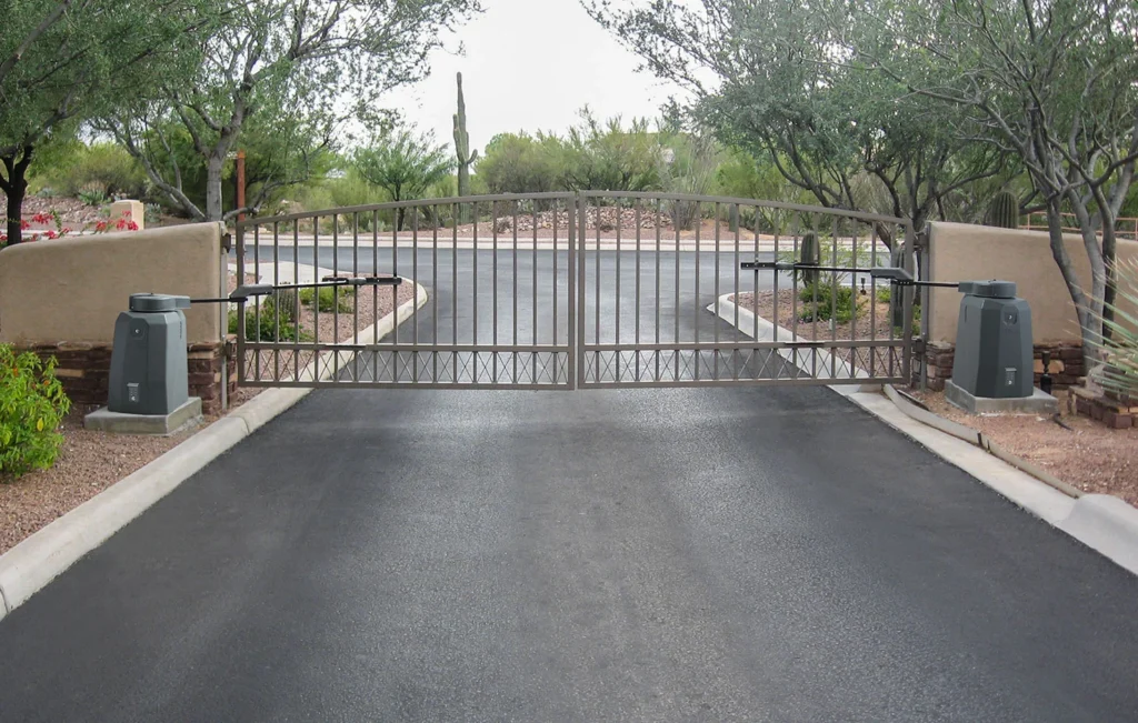 Dual swing gate setup with gate operators on both sides of a residential driveway, illustrating a gate access control system supported by the 1000 Power Inverter.