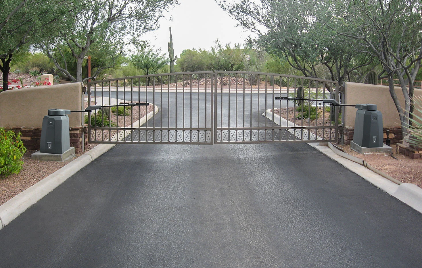 Dual swing gate setup with gate operators on both sides of a residential driveway, illustrating a gate access control system supported by the 1000 Power Inverter.
