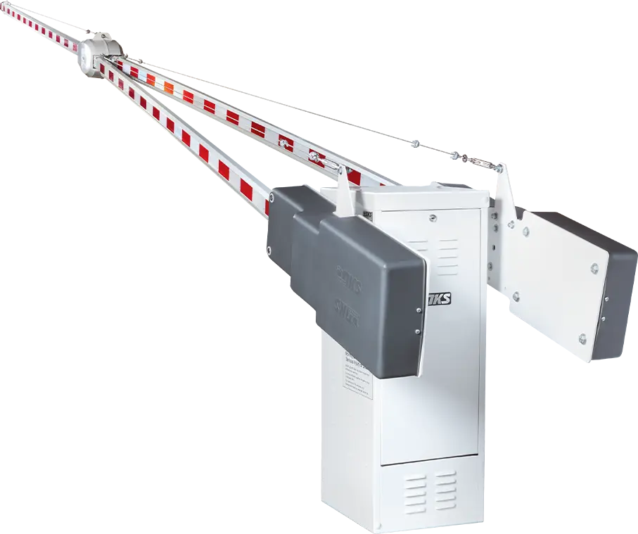 Side view of a DoorKing (DKS) Model 1602 heavy-duty parking control barrier gate operator. The industrial gray metal housing is shown with the counter-balanced wishbone-style barrier arm fully raised to the vertical open position. The unit features a 1 HP motor base, harmonic linkage mechanism, and is mounted on a concrete pad, typically used for wide traffic lanes in commercial and industrial settings.
