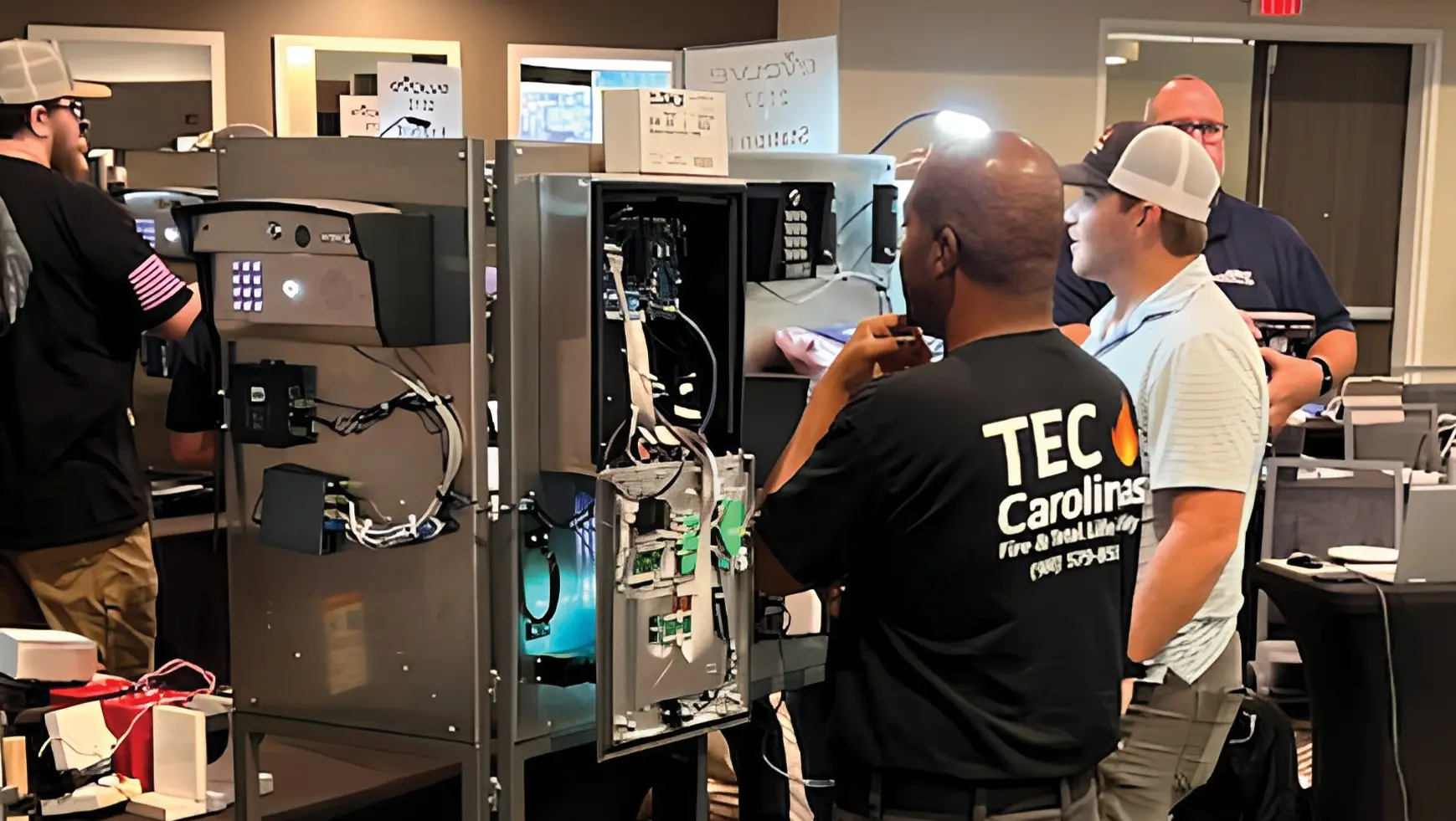 Professional DoorKing technician servicing and repairing the DKS 1837-90 Series slide gate operator during a training or field service demonstration.